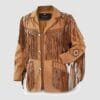Men's tan cowhide suede fringe jacket with braided trim, geometric shoulder accents, and concho-style sleeve medallions