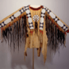 Women’s beaded suede war shirt with long dark hair trim and geometric beadwork