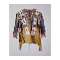 Woman wearing tan suede western fringe shirt with beaded detailing and fringe accents