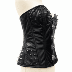 Side profile of a women's black spiked leather corset featuring silver cone spike embellishments and structured boning