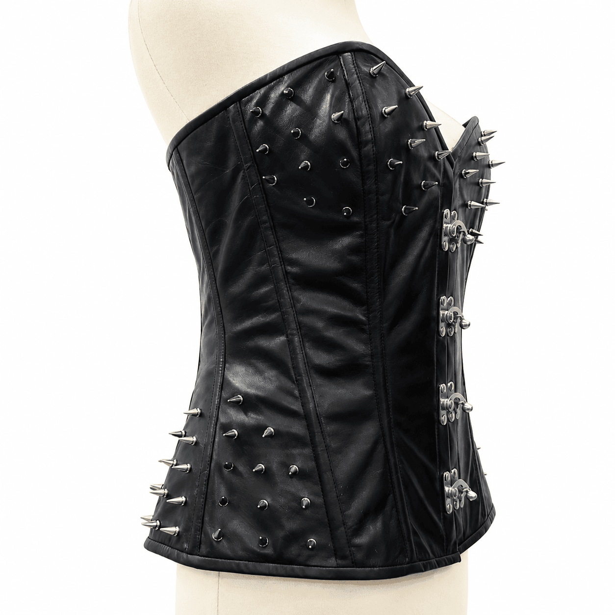 Side profile of a women's black spiked leather corset featuring silver cone spike embellishments and structured boning